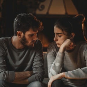 Man and woman sitting silently in frustration with each other